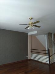 Living room with ceiling fan and wooden flooring