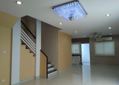 modern living area with staircase and chandelier