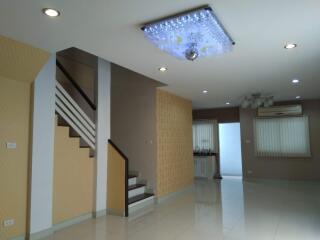 modern living area with staircase and chandelier