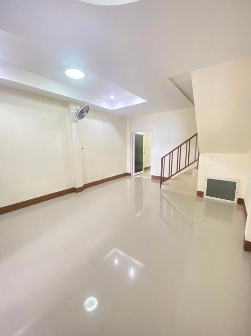 Spacious living room with staircase