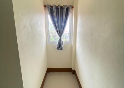 Narrow hallway with a window and curtain