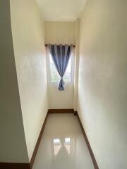 Narrow hallway with a window and curtain