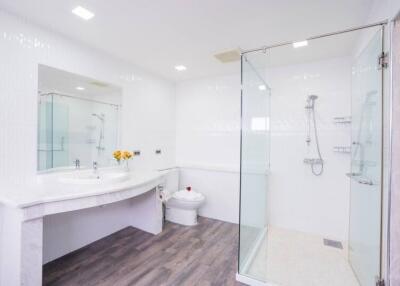 Modern bathroom with glass shower and large vanity mirror