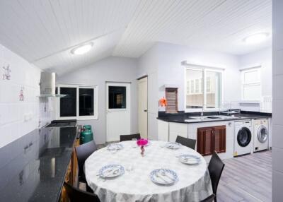 Spacious and well-lit kitchen with dining area