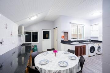 Spacious and well-lit kitchen with dining area