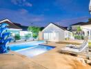 Beautiful outdoor area with a swimming pool and lounge chairs at dusk