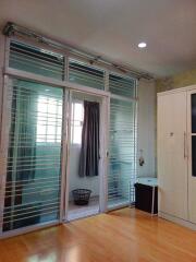 Bedroom with large windows and wooden floor