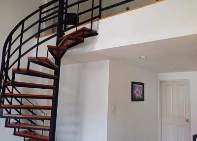 Living area with open staircase and upper loft