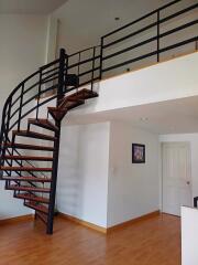 Living area with open staircase and upper loft