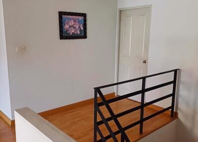 Small hallway with staircase and artwork