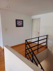 Small hallway with staircase and artwork