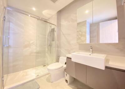 Modern bathroom with a glass-enclosed shower and a large mirror