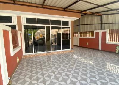 Spacious covered outdoor patio with tiled flooring