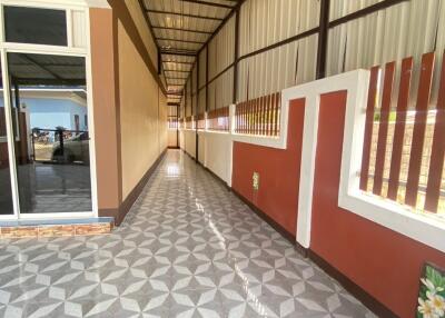 Long corridor with tiled flooring and partially open walls