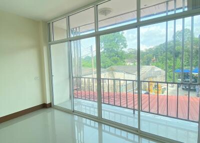 Spacious living room with large windows and balcony