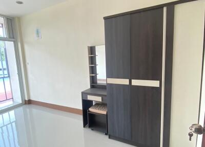 Spacious bedroom with large wardrobe and vanity desk