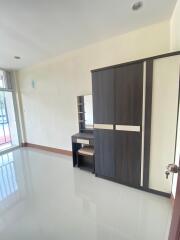 Spacious bedroom with large wardrobe and vanity desk