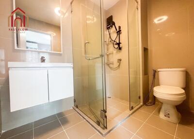 Modern bathroom with glass shower enclosure and white fixtures