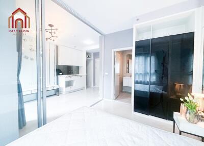 Modern bedroom with sliding doors and open view to kitchen