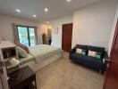 Bedroom with a pool view, featuring a bed, sofa, and bookshelf.