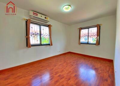 Bright bedroom with wooden flooring