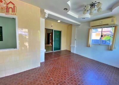 Spacious living room with tiled flooring and large window