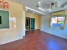 Spacious living room with tiled flooring and large window