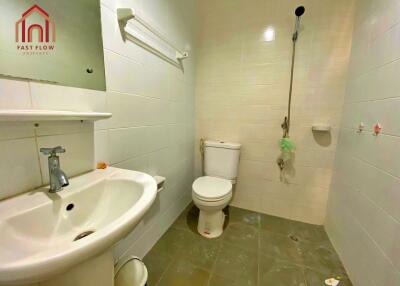 Bathroom with white tiles and essential fixtures