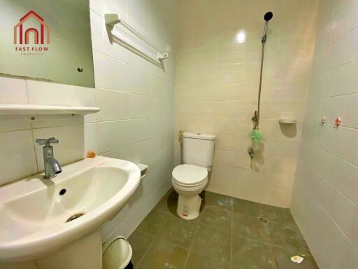 Bathroom with white tiles and essential fixtures