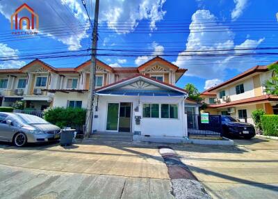 Front view of the house with a clear sky and parked cars