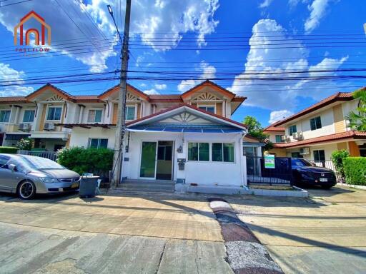 Front view of the house with a clear sky and parked cars