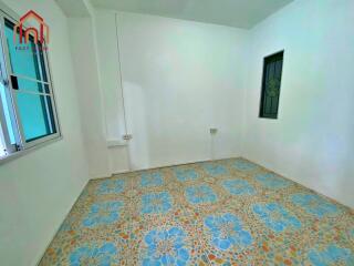 Empty bedroom with tiled floor and windows