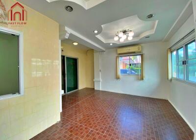 Spacious living room with tiled flooring and ceiling details