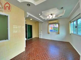 Spacious living room with tiled flooring and ceiling details