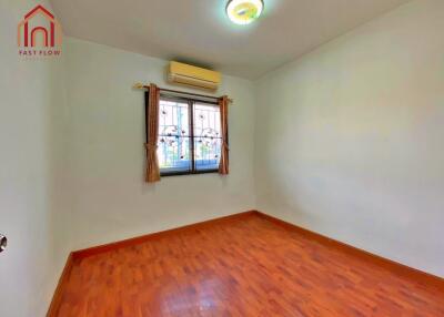 Empty bedroom with wooden floor and air conditioning