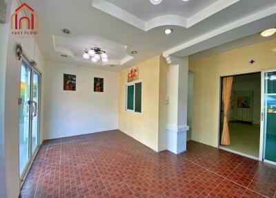 Spacious main living area with tiled flooring and modern lighting fixtures.