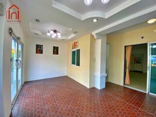 Spacious main living area with tiled flooring and modern lighting fixtures.