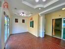 Spacious main living area with tiled flooring and modern lighting fixtures.