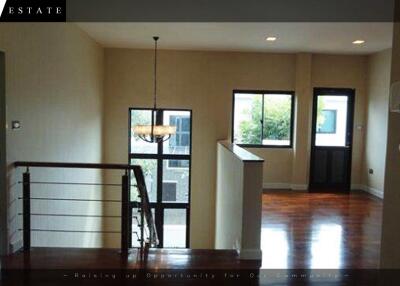 Spacious living room with wooden flooring and large windows