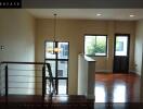 Spacious living room with wooden flooring and large windows