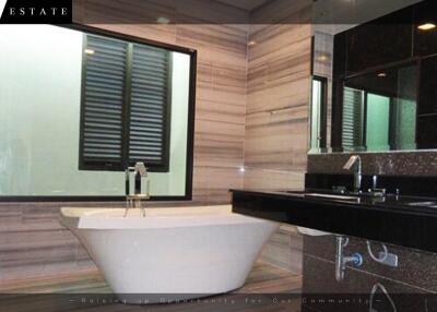 Modern bathroom with bathtub and dual sink vanity