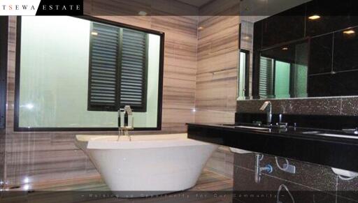 Modern bathroom with bathtub and dual sink vanity