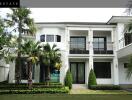 Modern two-story house exterior with palm trees and manicured lawn