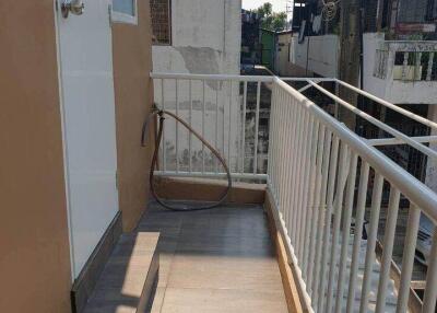 Outdoor balcony area with door and railing