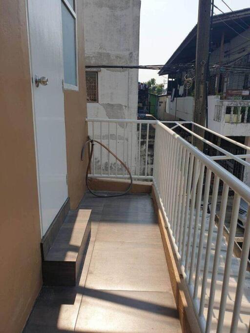 Outdoor balcony area with door and railing