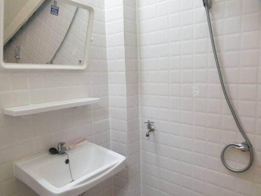 Small bathroom with sink, mirror, and shower