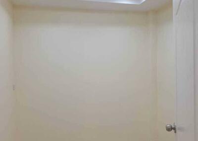 Empty room with beige walls and recessed lighting