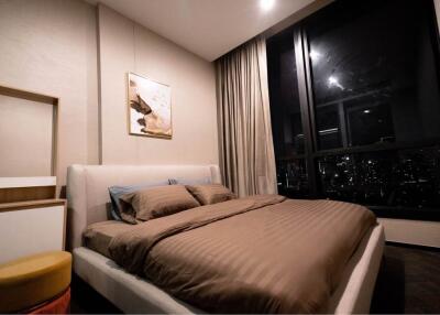 Modern Bedroom with Large Window View at Night