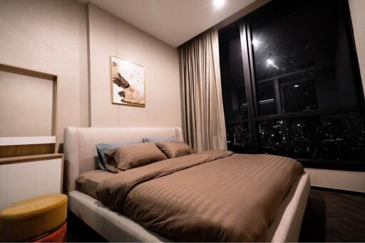 Modern Bedroom with Large Window View at Night