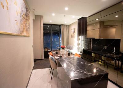 Modern dining area connected to a well-lit living space